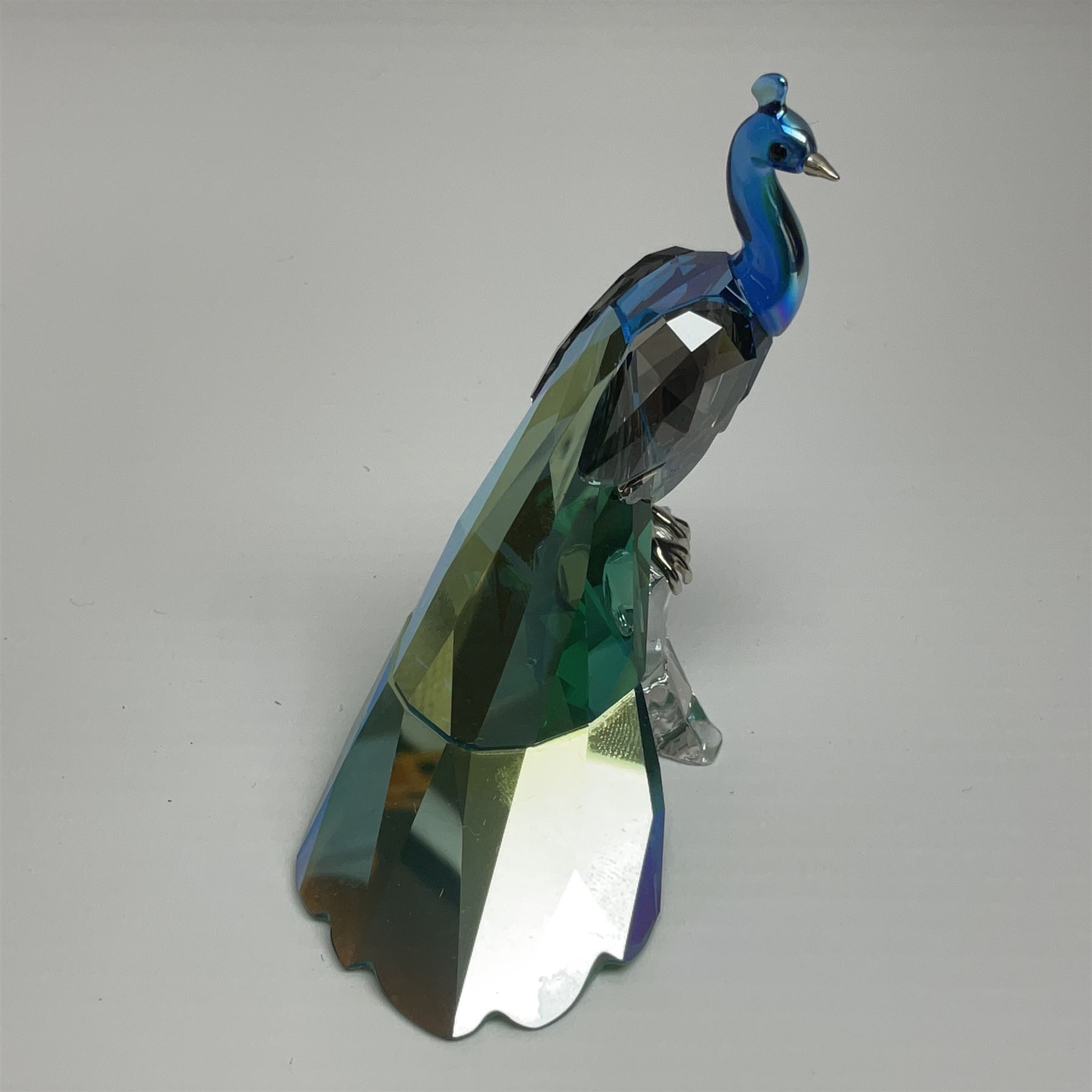 Swarovski Crystal SCS Edition peacock, Arya, together with a Swarovski Crystal peacock, perched on rock and small Swarovski Crystal sign, with peacock motif, tallest H11cm