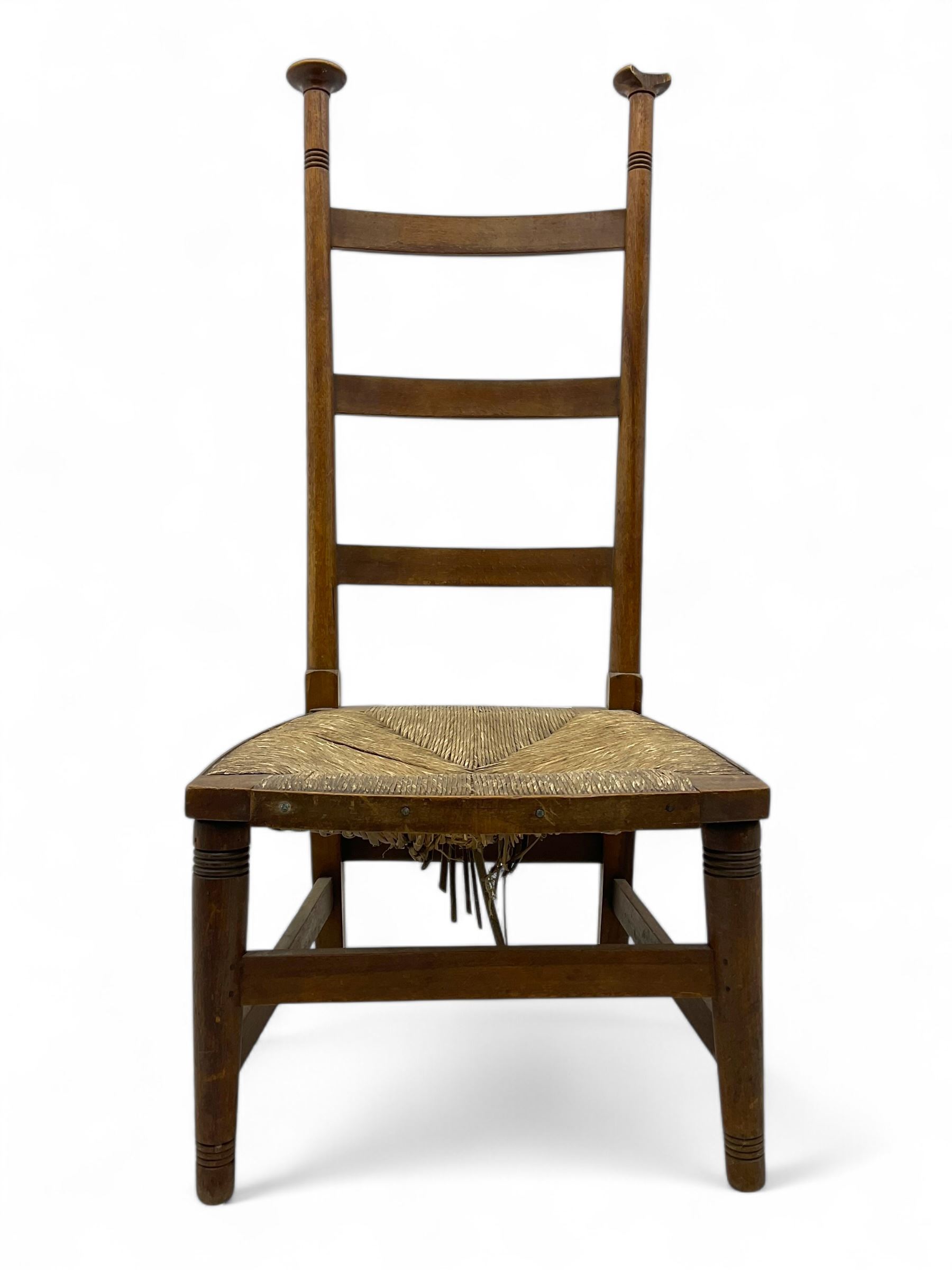 Attributed to William Birch of High Wycombe - Arts & Crafts oak ladder-back side chair, with turned finials, rush seat, and stretchers, raised on square-section supports; 19th century mahogany Pembroke table, rectangular drop-leaf top raised on turned supports with central stretcher and splayed feet