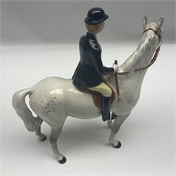 Beswick hunting group, comprising huntswoman on grey horse no 1730, huntsman on brown horse no 1501, fox figure no 1440 and eight fox hounds, all with printed marks beneath (11)