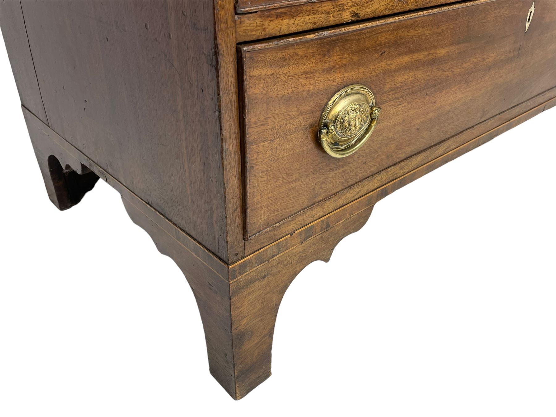 George III mahogany bureau, the fall-front banded and with boxwood stringing, enclosing fitted interior with pigeonholes and drawers surrounding a central cupboard with inlaid shell motif, the base with four graduating cock-beaded drawers, each with pressed brass handle plates with central lion masks and ivory escutcheons, on shaped bracket feet
This item has been registered for sale under Section 10 of the APHA Ivory Act
