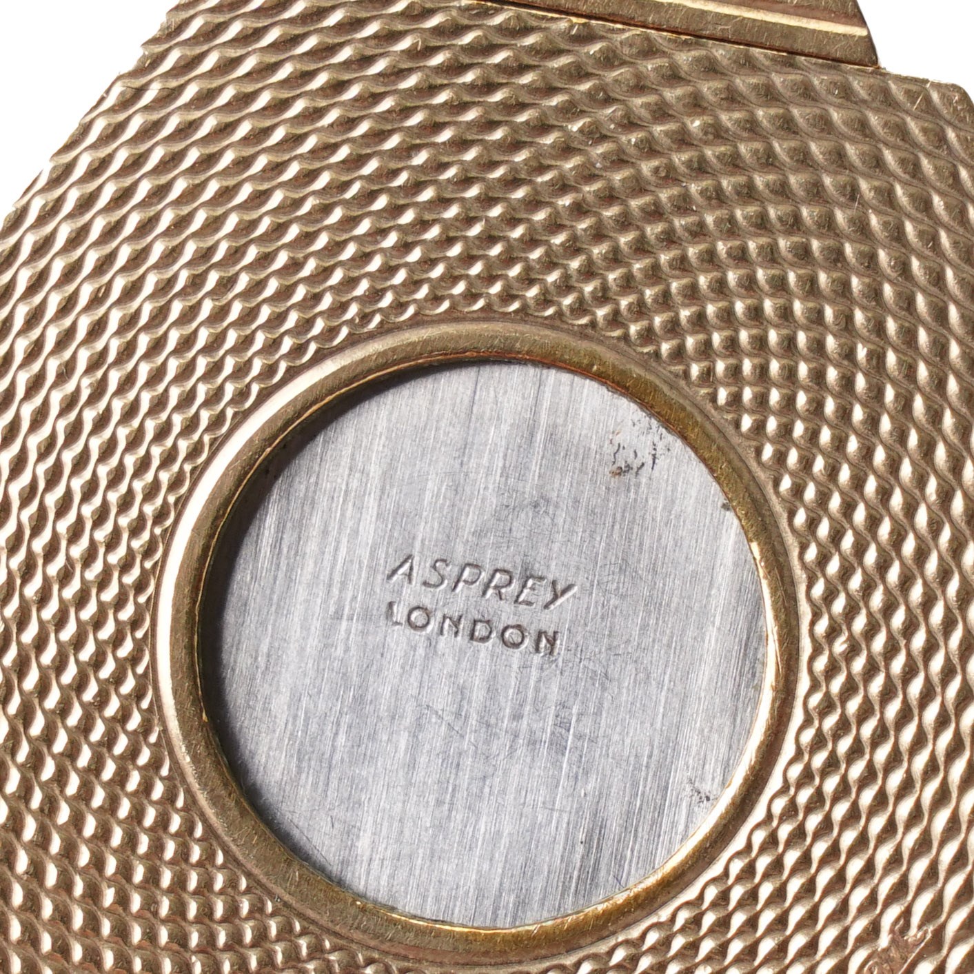 Asprey, 9ct gold hexagonal cigar cutter, hallmarked, with engine turned decoration  
