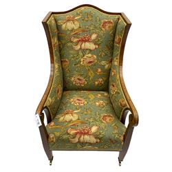 Edwardian mahogany armchair, inlaid with stain and boxwood, shaped cresting rail and scroll arms, square tapering supports with brass castors, upholstered in ' Leighton' by Margarita Cushing