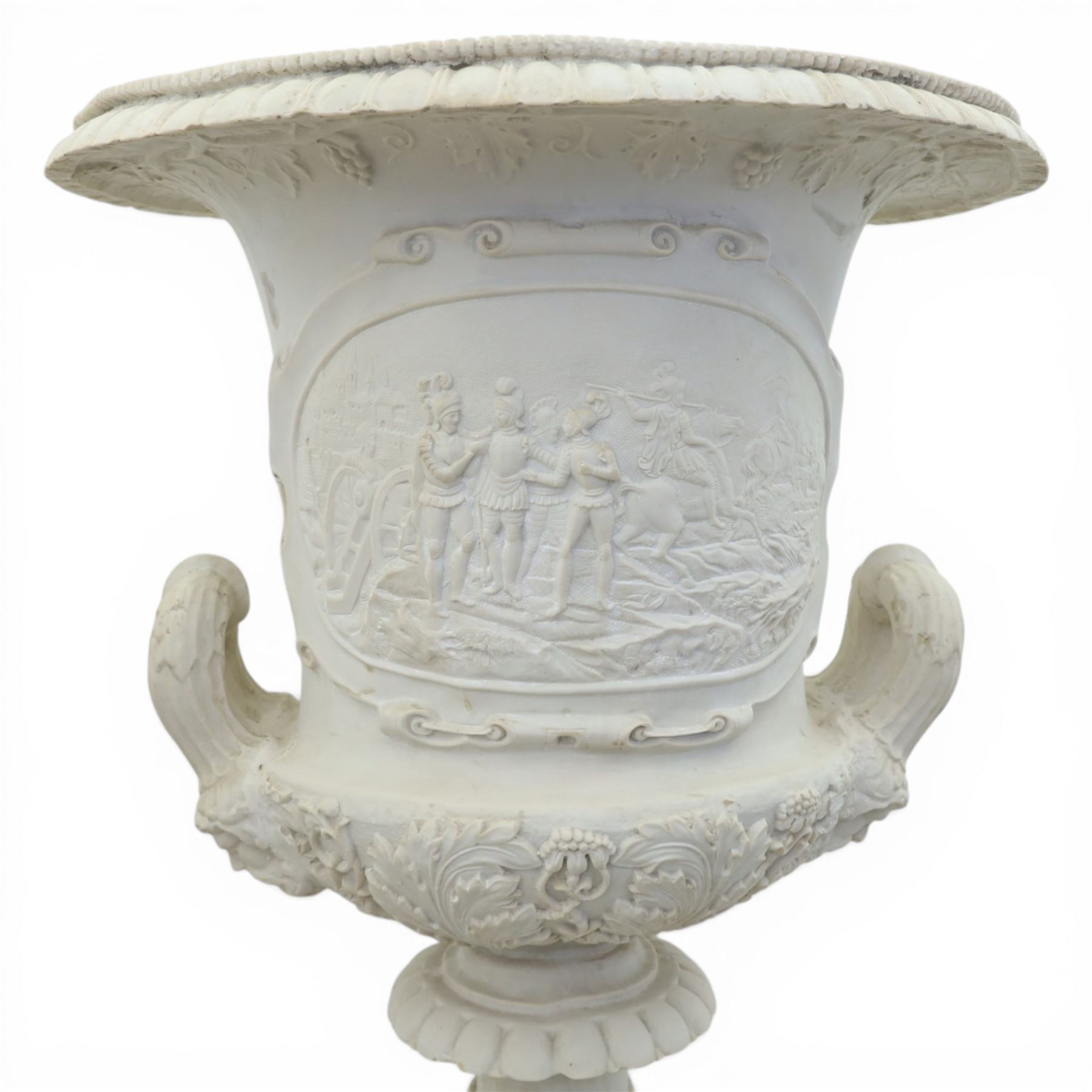 Pair of composite campana urns on stands, the urns decorated with relief figural panels and foliate bands with scrolling handles, on circular socles, the pedestals of square tapering form with moulded edges and applied classical motifs