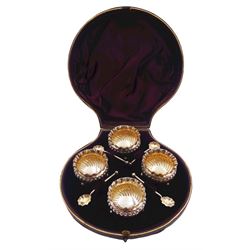 Set of four Victorian silver open salts, each of circular part fluted form with crimped rim, upon three ball feet, and four conforming salt spoons with crimped bowls, hallmarked Thomas Hayes, Birmingham 1887, in fitted case with maroon velvet and silk lined interior, approximate silver weight 3.79 ozt (118 grams)
