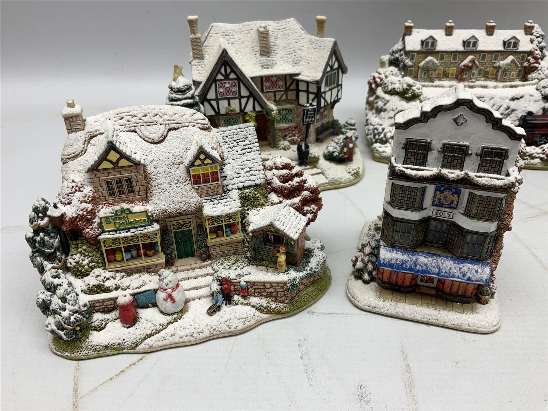 Five Lilliput Lane Illuminated Cottages, comprising Christmas is Coming, with box and deed, Christmas at Mol's, with box and deed, Christmas in Canterbury, with box and deed, Christmas Lights at Sweet Delights and The Three Kings, with box and deeds, together with twelve other Lilliput lanes, to include The First Noel, with box and deed, Winters Moonlight, Yuletide treats, with box and deed etc (17)