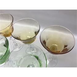 Ten coloured Adriana wine glasses by Abigails, to include blue, green, pink and yellow examples, each with part faceted bowl and twist stems, together with two similar orange examples with pulled stems, H24cm