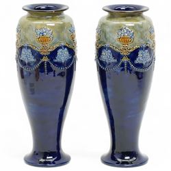 Pair of Royal Doulton stoneware vases, of baluster form, each with raised swag decoration,...
