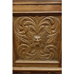  Late 19th century heavily carved oak dresser, raised back with lunette cornice above shelves and panelled cupboard carved with sea beasts, bow front bottom section with panelled doors, acanthus leaves and green man icon, on scrolled feet, labelled 'Bowman Brother, Camden', W142cm, H205cm, D54cm  