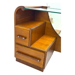Early 20th century Art Deco walnut dressing table, featuring a large oval triptych mirror above a stepped base, fitted with four drawers and a central glass shelf, all raised on a plinth base