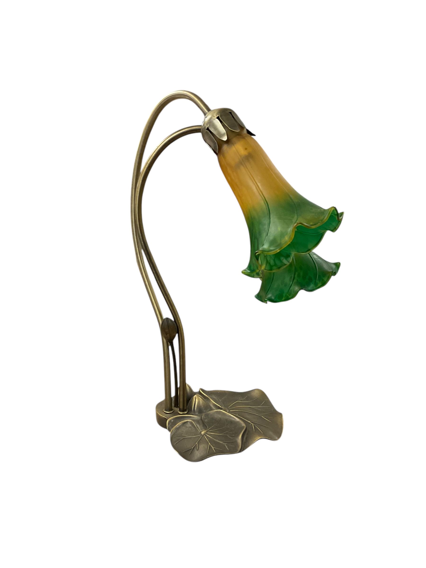 Art Nouveau inspired Tiffany style table lamp, with decorative lily pad base, and two amber and green tulip design glass shades, H40cm