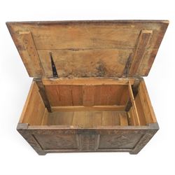 18th century oak coffer with carved frieze and rails, rectangular plank top with iron strap hinges, raised on stile supports
