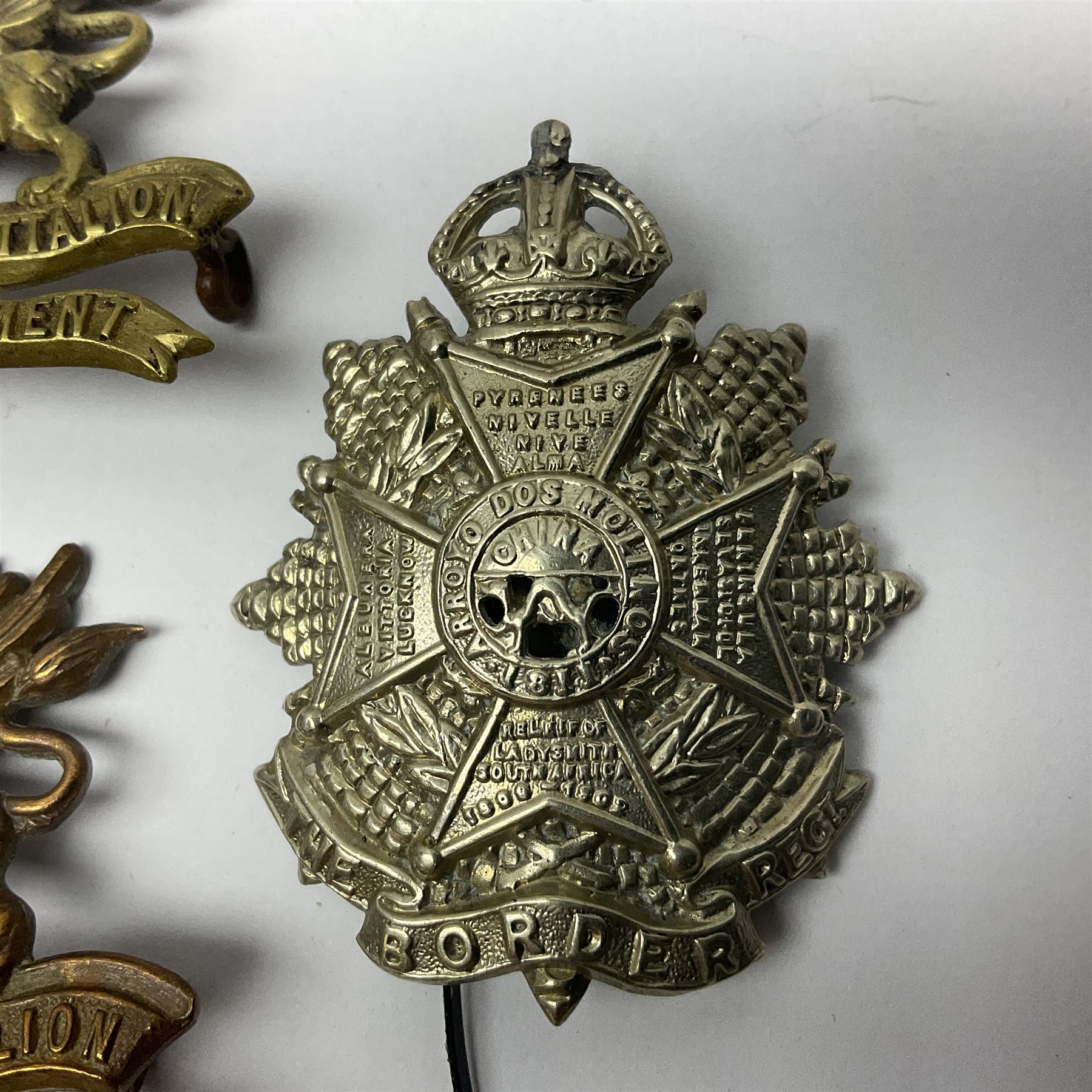 Four Border Regiment cap badges including eleventh battalion (4)
