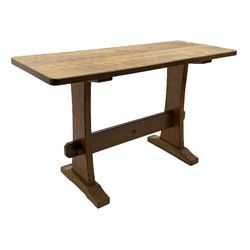'Acornman' oak table with rectangular adzed top, shaped end supports on sledge feet joined by pegged stretcher carved with acorn signature, by Alan Grainger of Brandsby, York