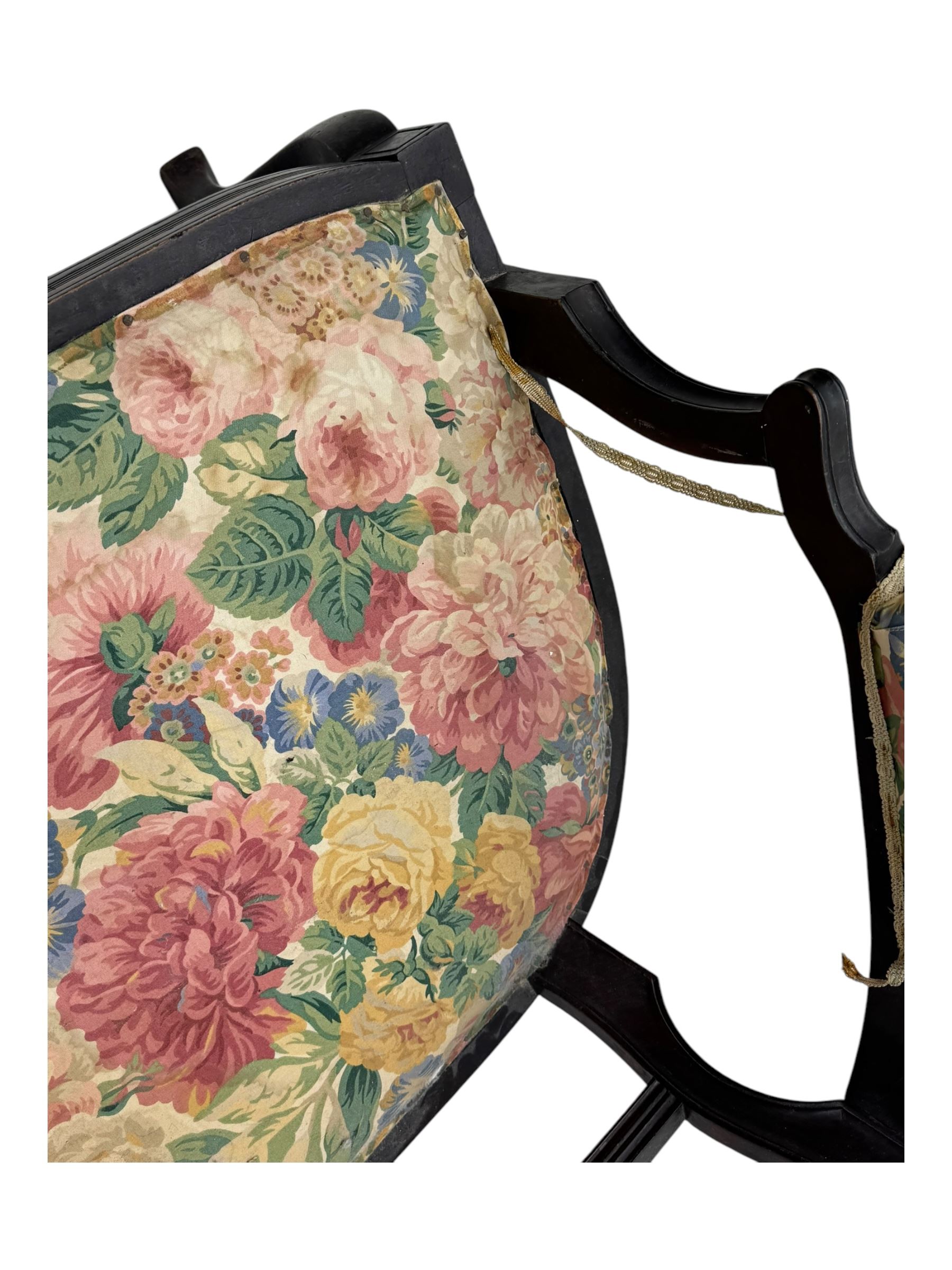 Edwardian mahogany three seater settee, upholstered in floral fabric. Shield back with padded armrests and cabriole legs  
