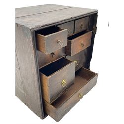 18th century oak spice cupboard, single panelled door enclosing eight drawers of various sizes, reed moulded front edges