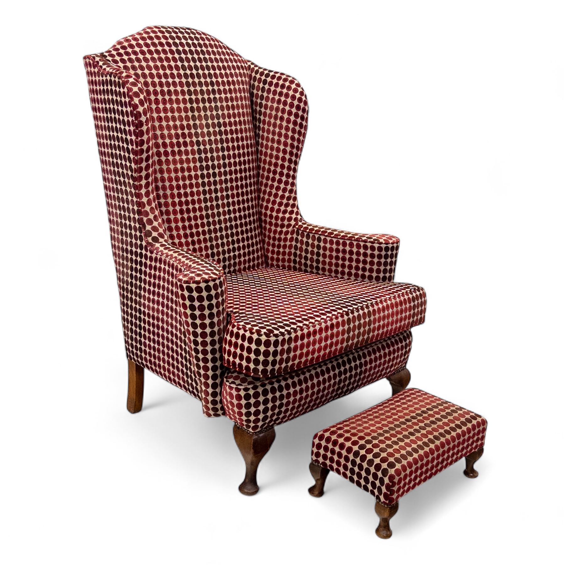 Late 20th century Georgian style wingback armchair with matching footstool, upholstered in red and cream geometric fabric, raised on cabriole front legs