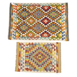 Two Chobi flatweave kilims with a repeating stepped diamond medallion design in live green...