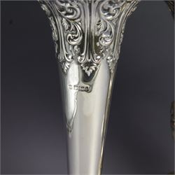 Three late 19th century/early 20th century silver vases, of trumpet form, all embossed with floral and foliate decoration, one example with weighted base, all hallmarked, tallest H18cm