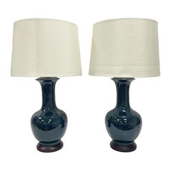 Pair of Chinese teal glazed table lamps, each of bottle form, raised upon circular hardwood bases, including shade H72cm 