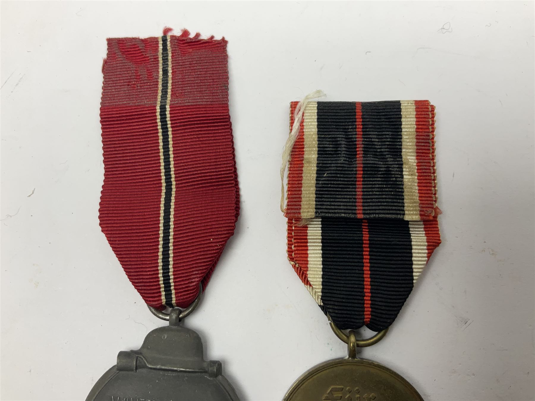 German War Merit Cross 1st Class, the pin-back stamped '50'; War Merit Medal; and Ostfront Medal for the Winter Campaign in Russia of 1941-1942 'Die Medaille Winterschlacht Im Osten'; all with ribbons (3)