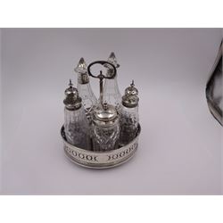 Late 18th century silver cruet stand, of oval form, with pierced sides upon four bun feet, hallmarked to handle Hester Bateman, all other hallmarks indistinct, together with five matched silver mounted cut glass cruet bottles, including some later Victorian examples, hallmarks predominantly indistinct, stand H20cm