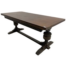 20th century oak drawer leaf extending dining table, two foliage carved baluster supports on sledge feet joined by floor stretcher 