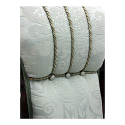 Late Victorian carved mahogany open armchair, the shaped back with fluted upholstered panel and padded arms above pierced scroll carved side supports, over a broad upholstered seat, on turned front supports