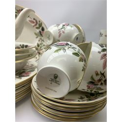 Wedgwood Hathaway Rose pattern dinner and tea wares, comprising eight dinner plates, eight salad plates, eight dessert plates, six side plates, six soup bowls and six saucers, sauce boat and stand, three oval serving dishes, oval serving platter, teapot, coffee pot, eight tea cups and eight saucers, eight coffee cans and eight saucers, two open sucriers, milk jug, cream jug, two ashtrays, and a lidded box and cover. 