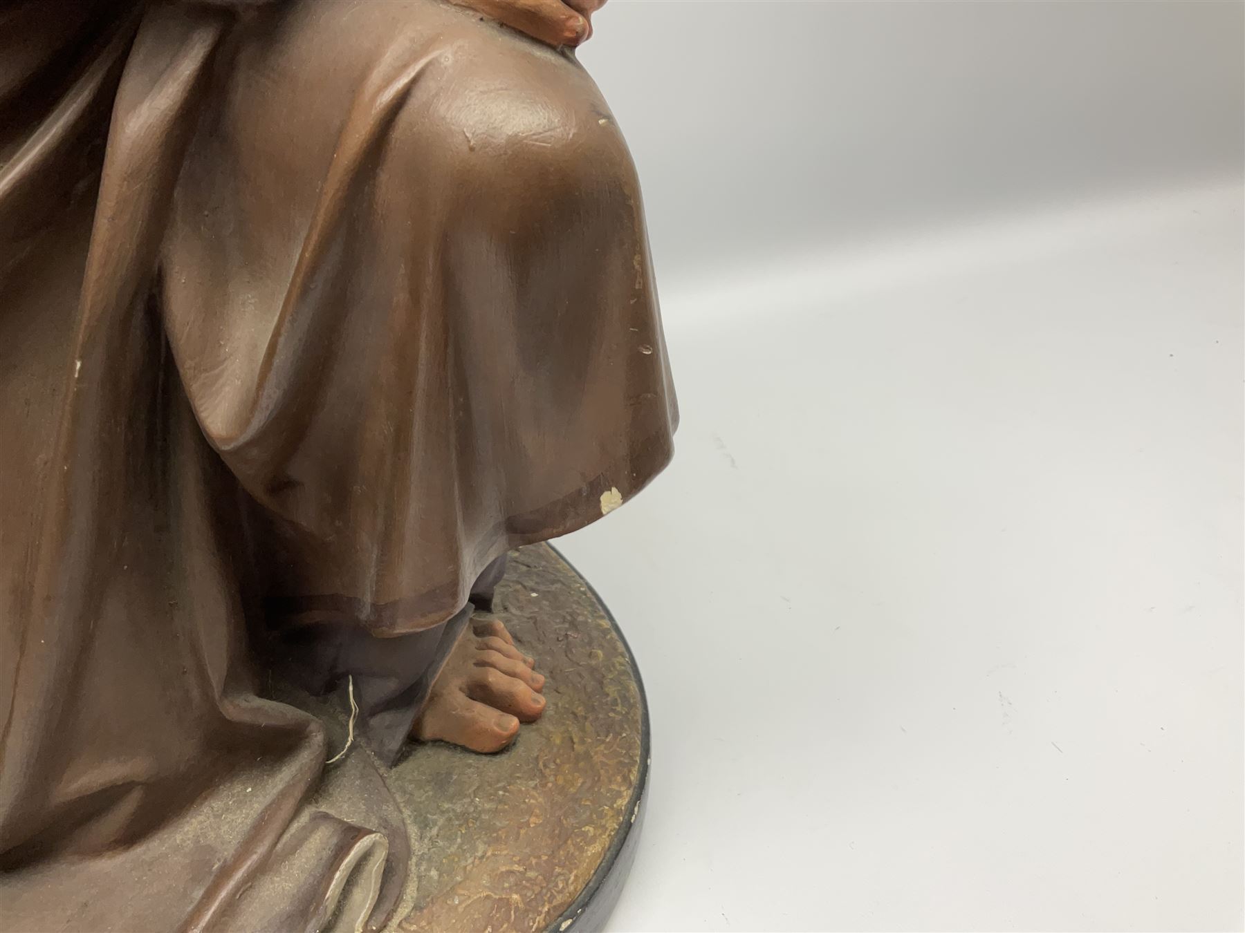 Two religious painted plaster figures of Mary and Joseph kneeling on oval plinths, with impressed mark 'Raffl et Cie Paris', H60cm 