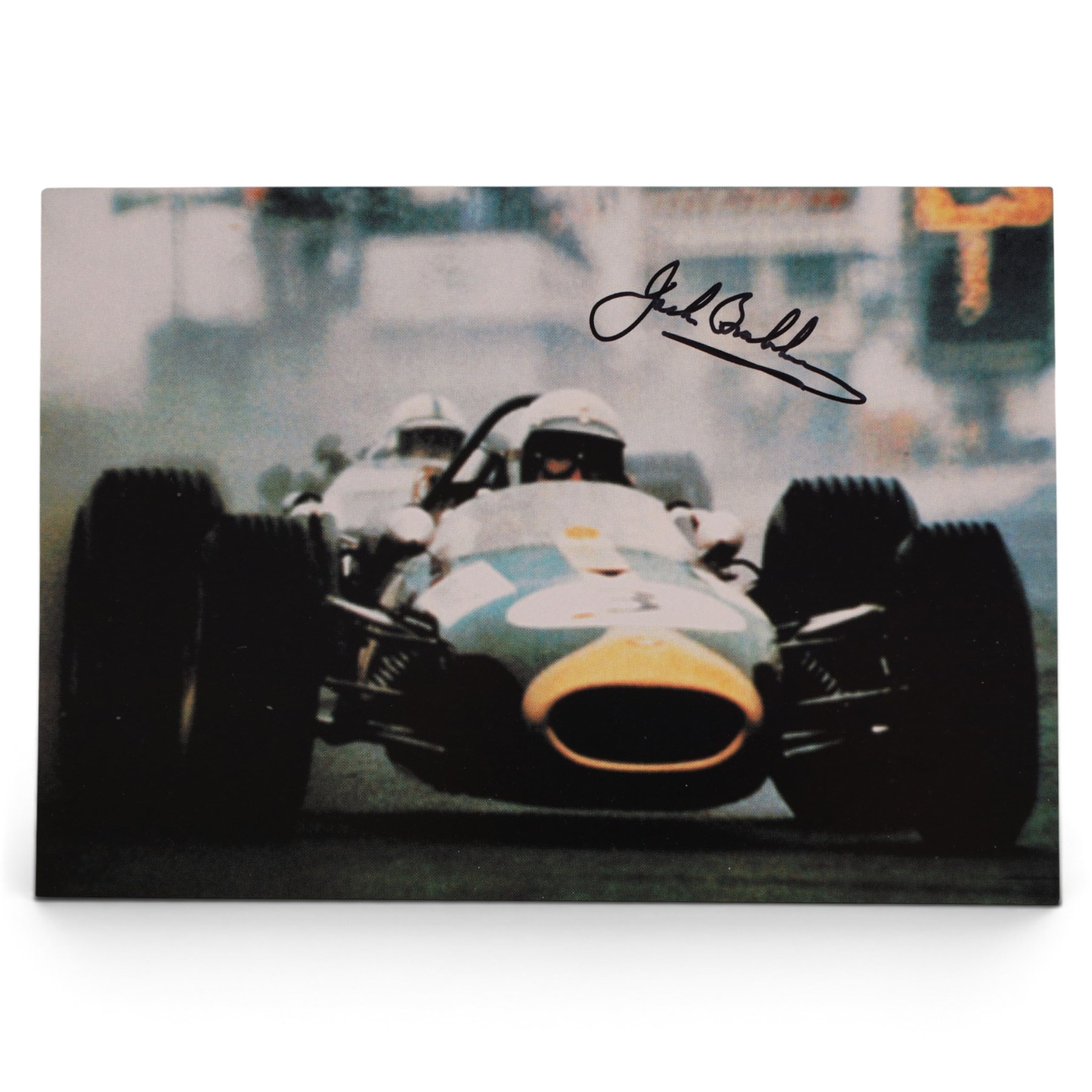 Signed Formula 1 memorabilia, including 1973 Milestones magazine signed to the front cover by Graham Hill and three signed photographs comprising Jackie Stewart, Jack Bradbury and Mario Andretti, with certificate of authenticity from Chaucer Auctions