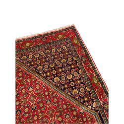 Persian Bijar red and blue ground rug, central panel decorated with tree of life and flower head motifs, decorated all-over with Herati motifs, triple band band border decorated with stylised plant motifs