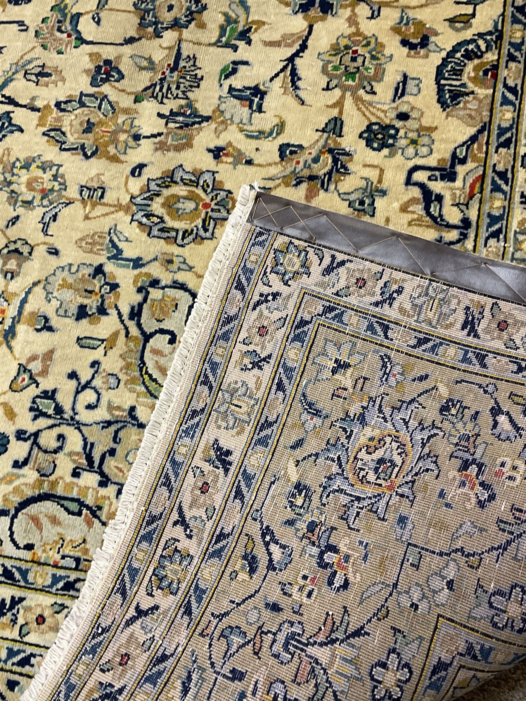 Central Persian Kashan carpet, decorated all-over with interlacing floral design, scrolling border with stylised plant motifs, with signed panel