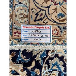 Central Persian Nain carpet, the deep blue field with finely drawn scrolling palmettes and flowering vines around a central ivory and sky blue rosette medallion, enclosed by an ivory border of interlaced floral arabesques and lotus forms between multiple guard stripes, from the region of Nain