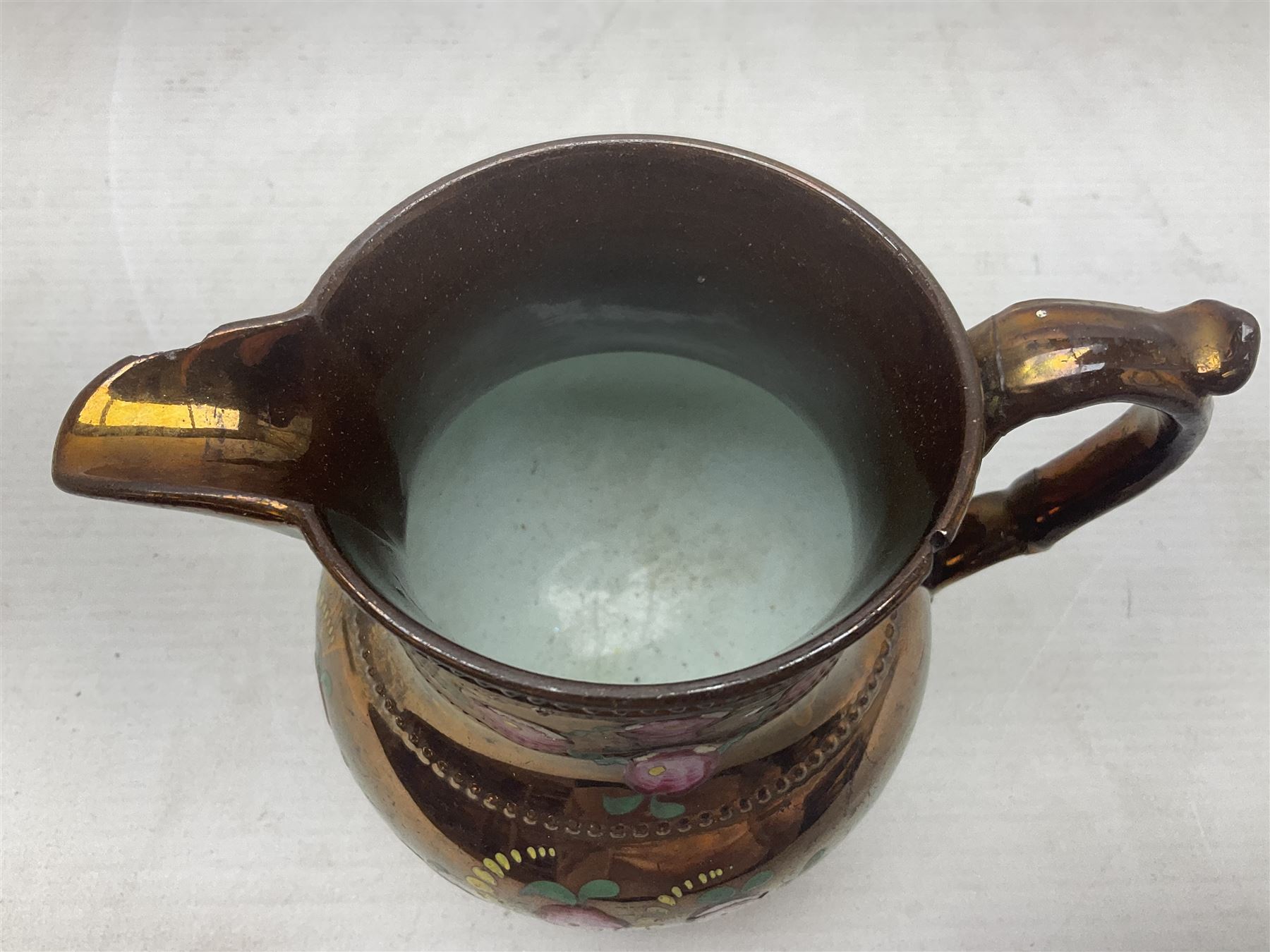 Early 20th century Sunderland lustre jug, decorated with transfer Masonic scene and poem 'The World is in Pain/Our Secrets to Gain/But Still Let Them Wonder and Gaze/The Never Can Divine/The World Nor The Sign/Of a Free and Accepted Mason', the reverse decorated with Sunderland River Wear cast iron bridge scene below text (a/f), together with a copper lustre jug, and pink lustre bowl, jug H20cm