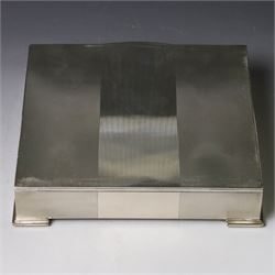 1960s silver mounted cigarette box, of rectangular form with engine turned decoration, upon four bracket feet, with presentation engraving to interior lid reading  'British Aircraft Corporation (Operating) Limited Commemorating the Queen's Award to Industry 1967, hallmarked James Geraghty, Birmingham 1965, with retailers mark for Asprey, W16.5cm, H4.5cm, in Garrard & Co Jewellers box