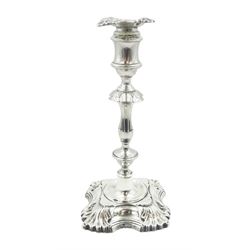 Early 20th century George II style silver candlestick, the filled quatrefoil base with fluted corners leading to a knopped stem and socket with conforming removable nozzle, hallmarked William Hutton & Sons Ltd, Sheffield, date letter worn and indistinct, H22.5cm