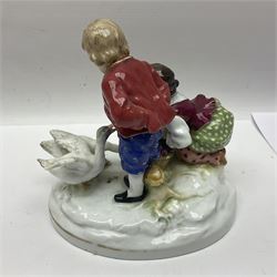 Two 19th century german figures, each modelled as children feeding birds, H19cm 