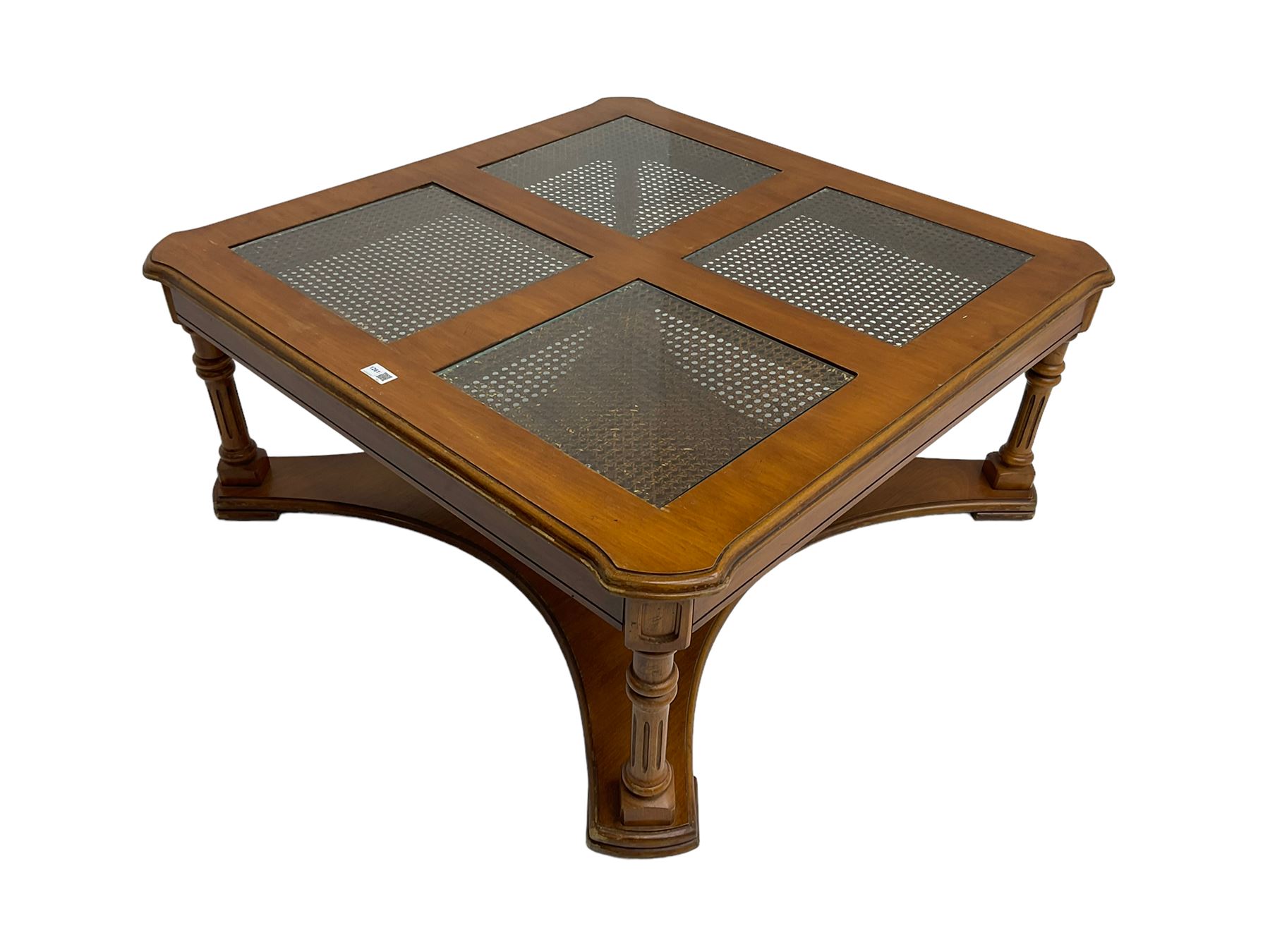 Coffee table, square top with cane work insets, raised on four fluted column supports joined by shaped base