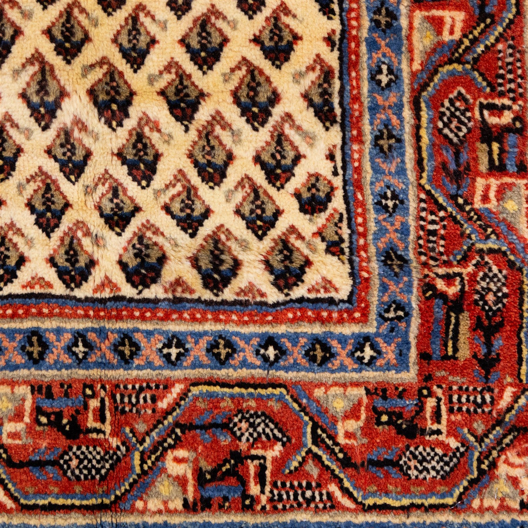 West Persian Boteh-Mir hand-knotted rug, ivory field densely decorated with a repeating lattice of of small boteh motifs arranged in diagonal rows enclosed by a broad border of stylized geometric devices and angular floral ornament between multiple guard stripes with cotton fringe ends 