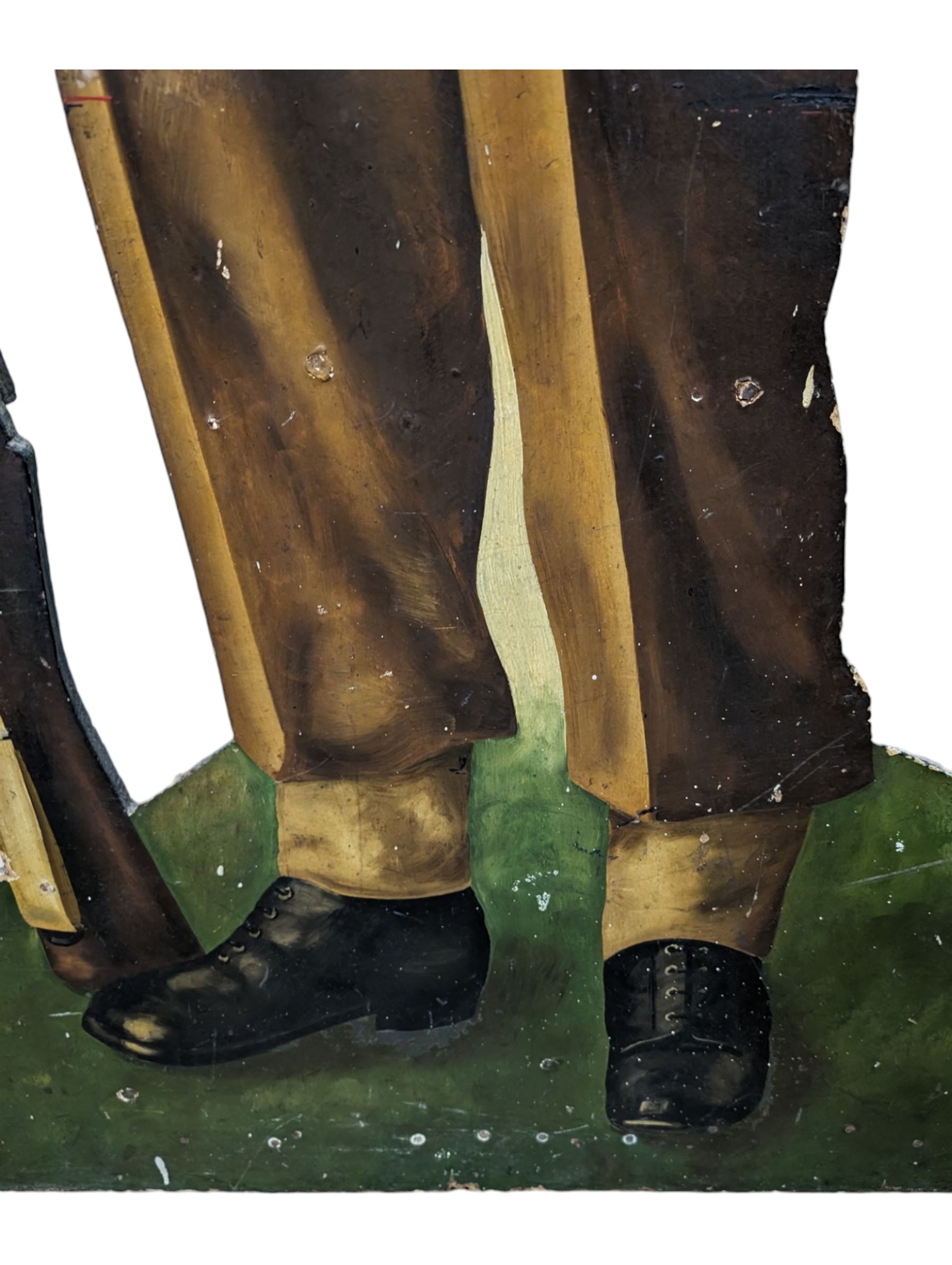 Military Outfitters hand painted life size wooden cut out figure of a WW1 soldier standing at ease holding a gun by his side, marked Stening Signs; hardboard on planked frame H199cm