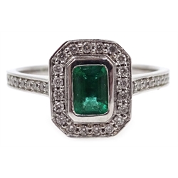  White gold emerald cut emerald and round diamond cluster ring, with diamond set shoulders, hallmarked 18ct   