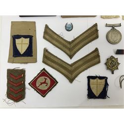 WWII group of three medals comprising 1939-45 War Medal and Italy and Africa Stars in issue box; dog tags for 282894 W. Wilkinson with framed photograph in uniform; and small quantity of cloth and metal badges including RAOC cap badge