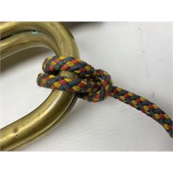 Two military brass bugles by Mayers and Harrison Ltd. Manchester each with crows foot mark and dated 1966; both with multi-coloured cord and tassels, longest 52.5cm (2)