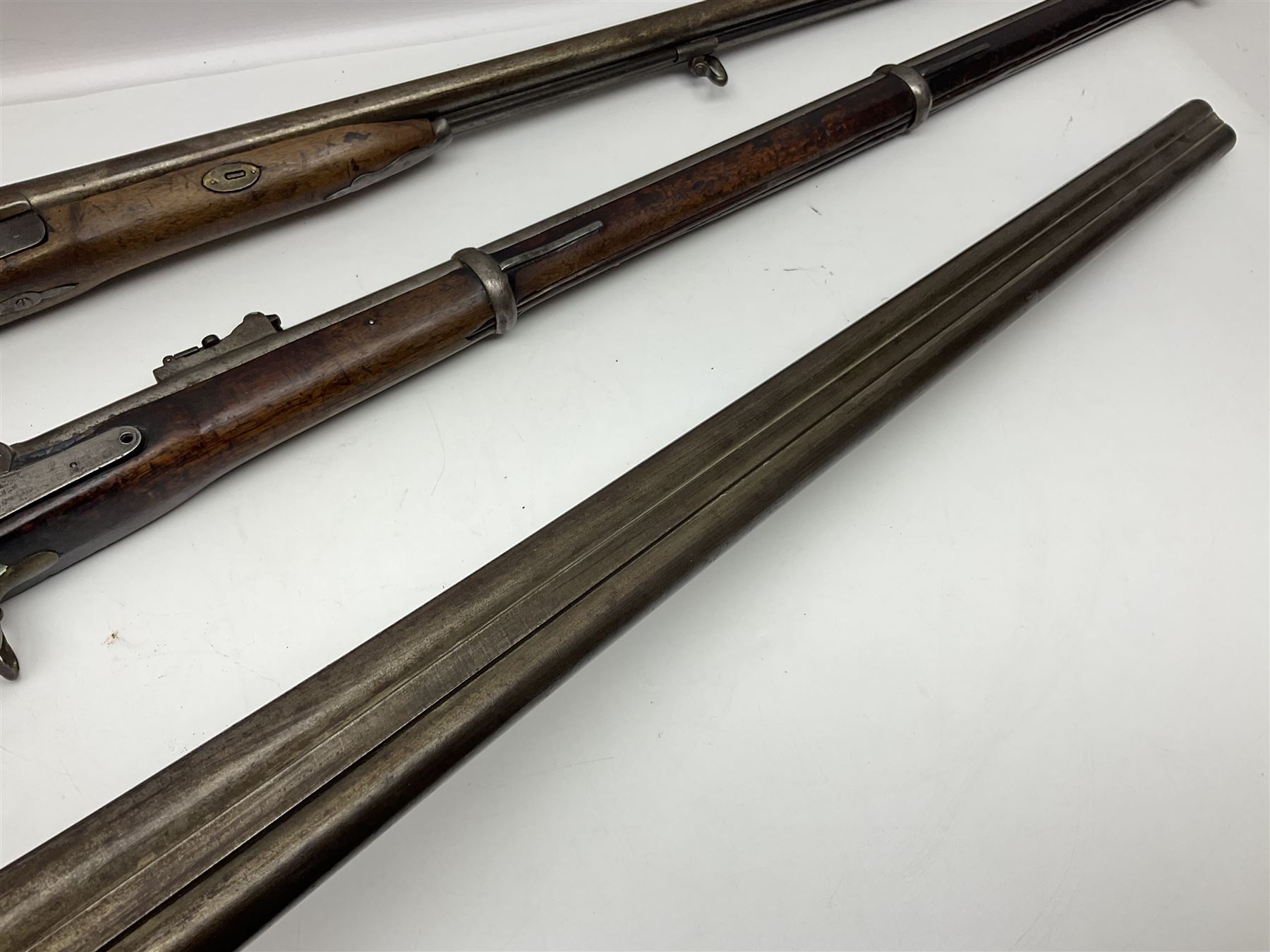 19th century Indian .577 Enfield muzzle loading rifle, proofed for 26-bore, the 98.5cm barrel with three barrel bands and later ram rod L140cm overall; 19th century Belgian side-by-side double barrel percussion shotgun, approximately 20-bore, with 74cm barrels and studded walnut stock, lock plate marked 'Liege 1868' and 'V. Gulikers-Maquinay' L117cm overall; and another side-by-side double barrel shotgun by Smythe with underlever opening (3)