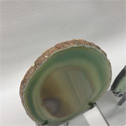 Pair of green agate slices, polished with rough edges raised upon silvered metal stands, H19cm