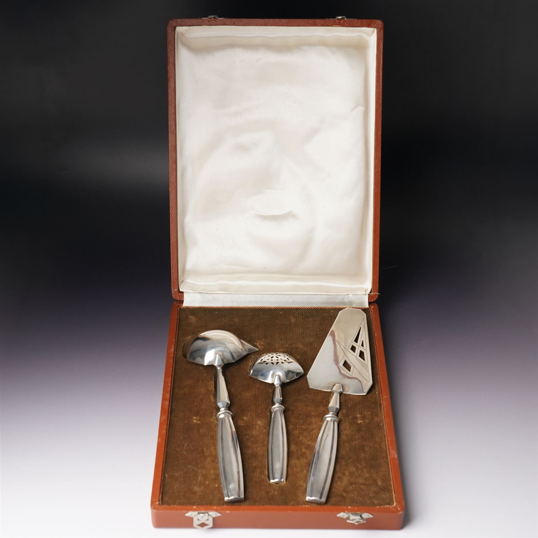 Scandinavian white metal three piece serving set comprising pastry slice, sauce ladle and sifting spoon with fluted handles, cased