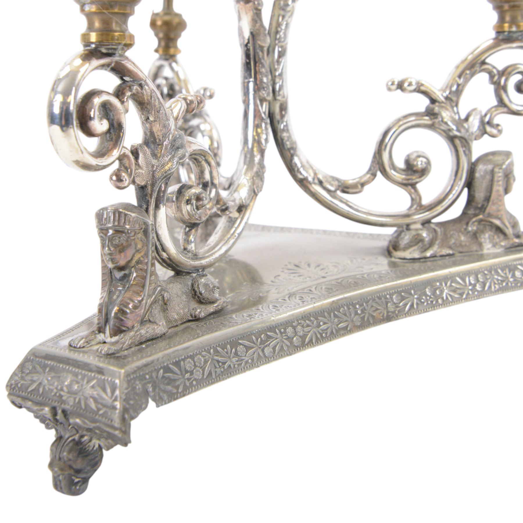 Silver plated Egyptian Revival lamp, with scrolling columns, on a trefoil base, surmounted by three sphinxes, with mask feet, H60cm