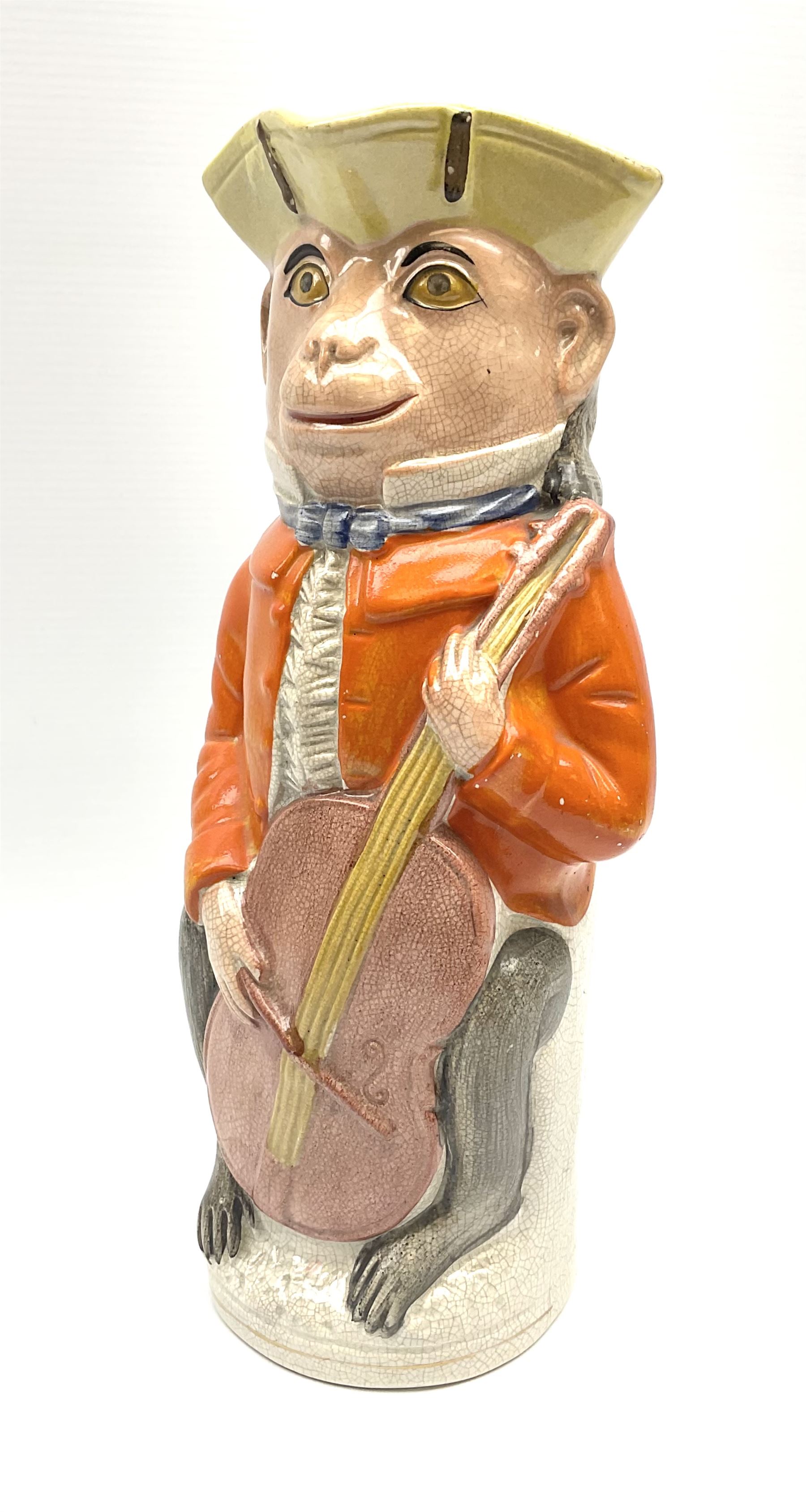 19th century Staffordshire Toby jug modelled as a monkey playing a cello H30cm. 