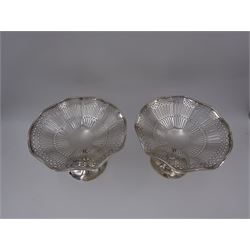 Pair of Edwardian silver pedestal dishes, each with fluted rim and pierced geometric decoration to bowls, upon tapered stem and domed circular foot, hallmarked Stewart Dawson & Co Ltd, London 1909, H11.5cm