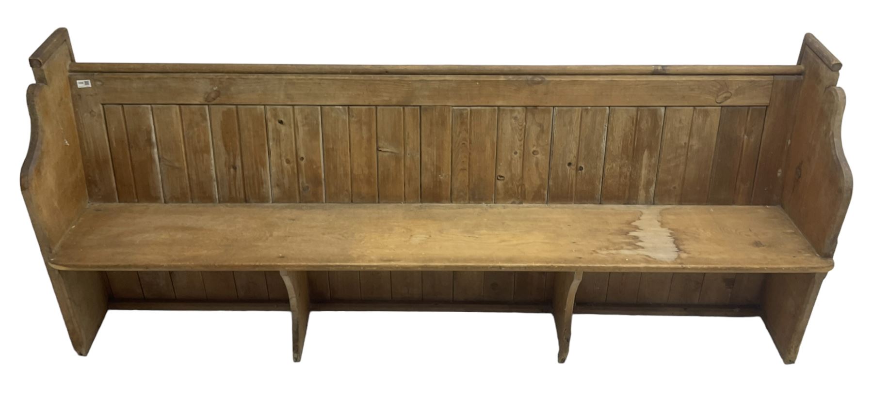 Early 20th century pine church pew, vertical plank back over rectangular seat, flanked by shaped end supports, with bible rest to back